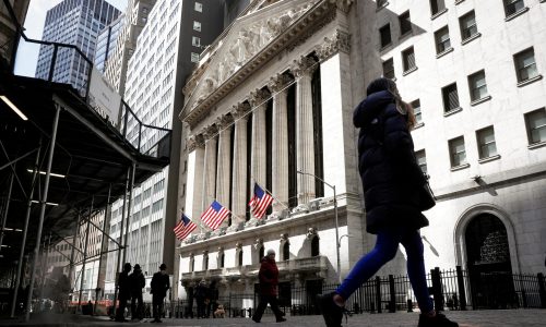 FILE PHOTO: People are seen on Wall Street outside the New York Stock Exchange (NYSE) in New York City, U.S., March 19, 2021.  REUTERS/Brendan McDermid